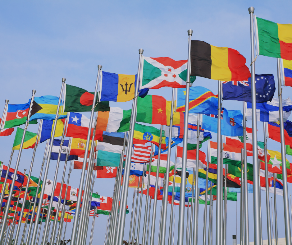 Many flag poles with flags on countries around the world waving in the breeze