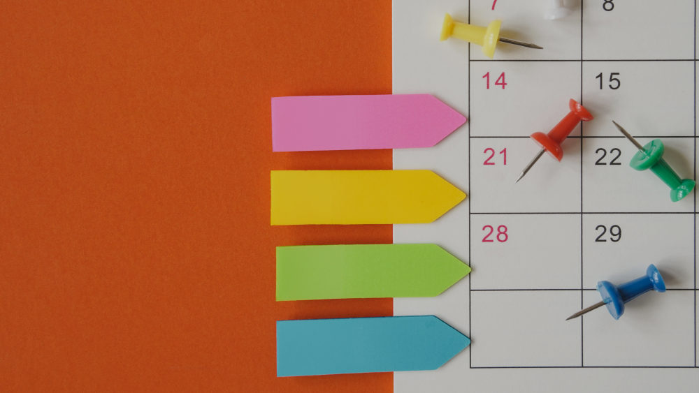 Calendar with post it reminders and drawing pins
