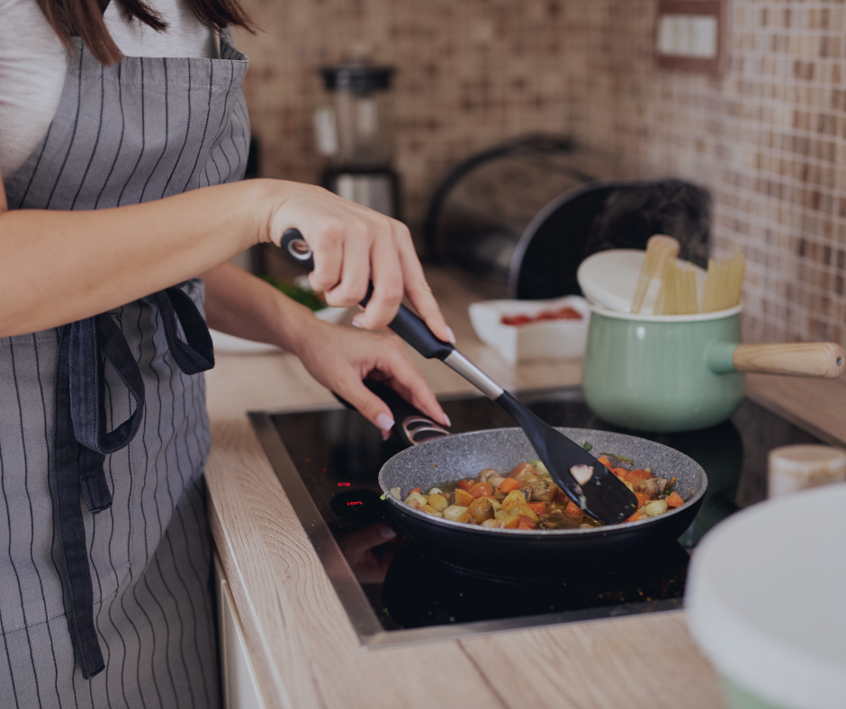 Teen cooking vegetables on an electric cooker